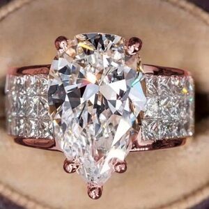 Gold Pear-Cut Solitaire Ring with Channel-Set Side Stones